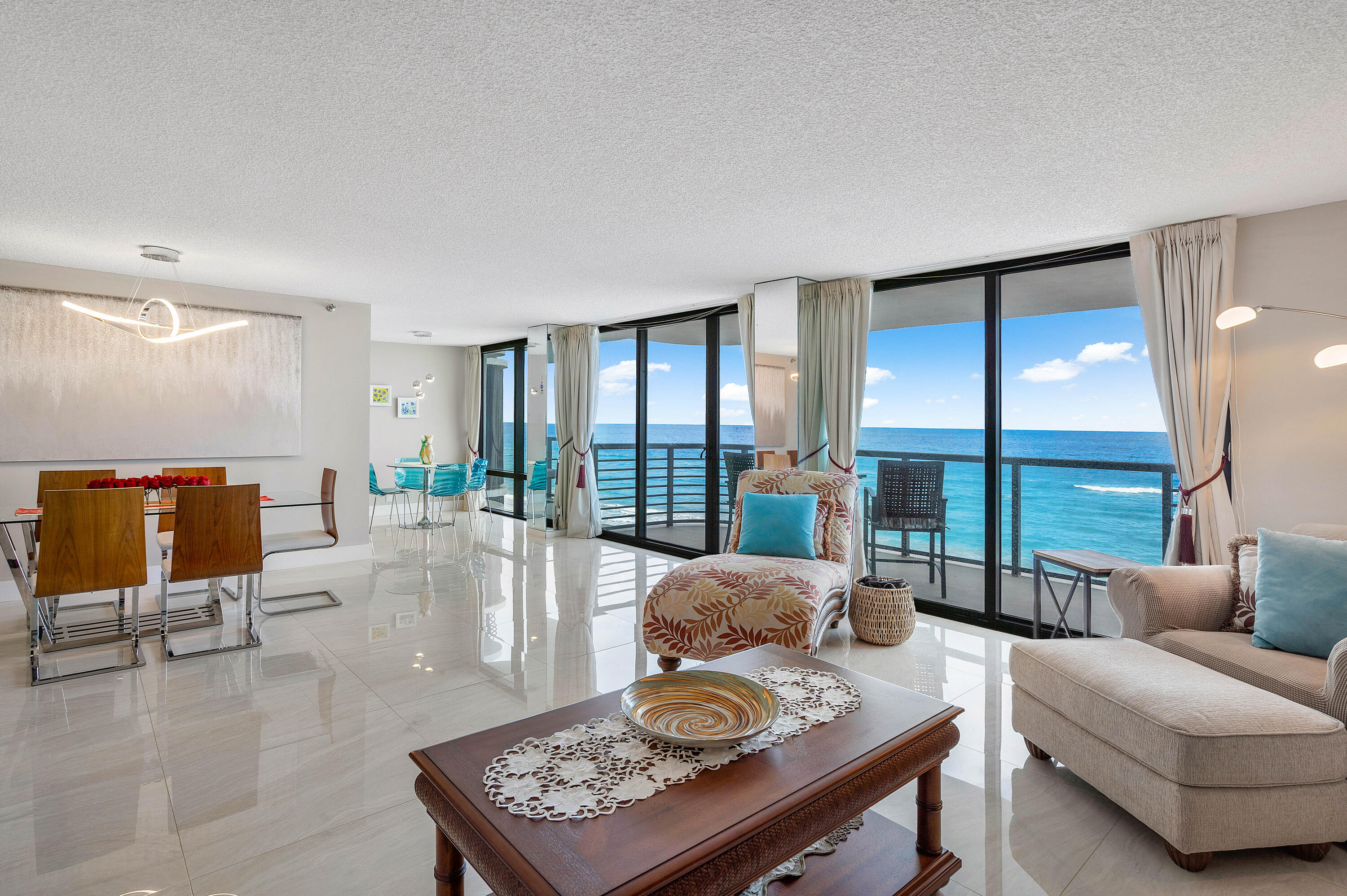250 South Ocean Boulevard, Unit 7E Boca Raton, FL 33432 - Photo 8 of 45 a living room with furniture and a floor to ceiling window