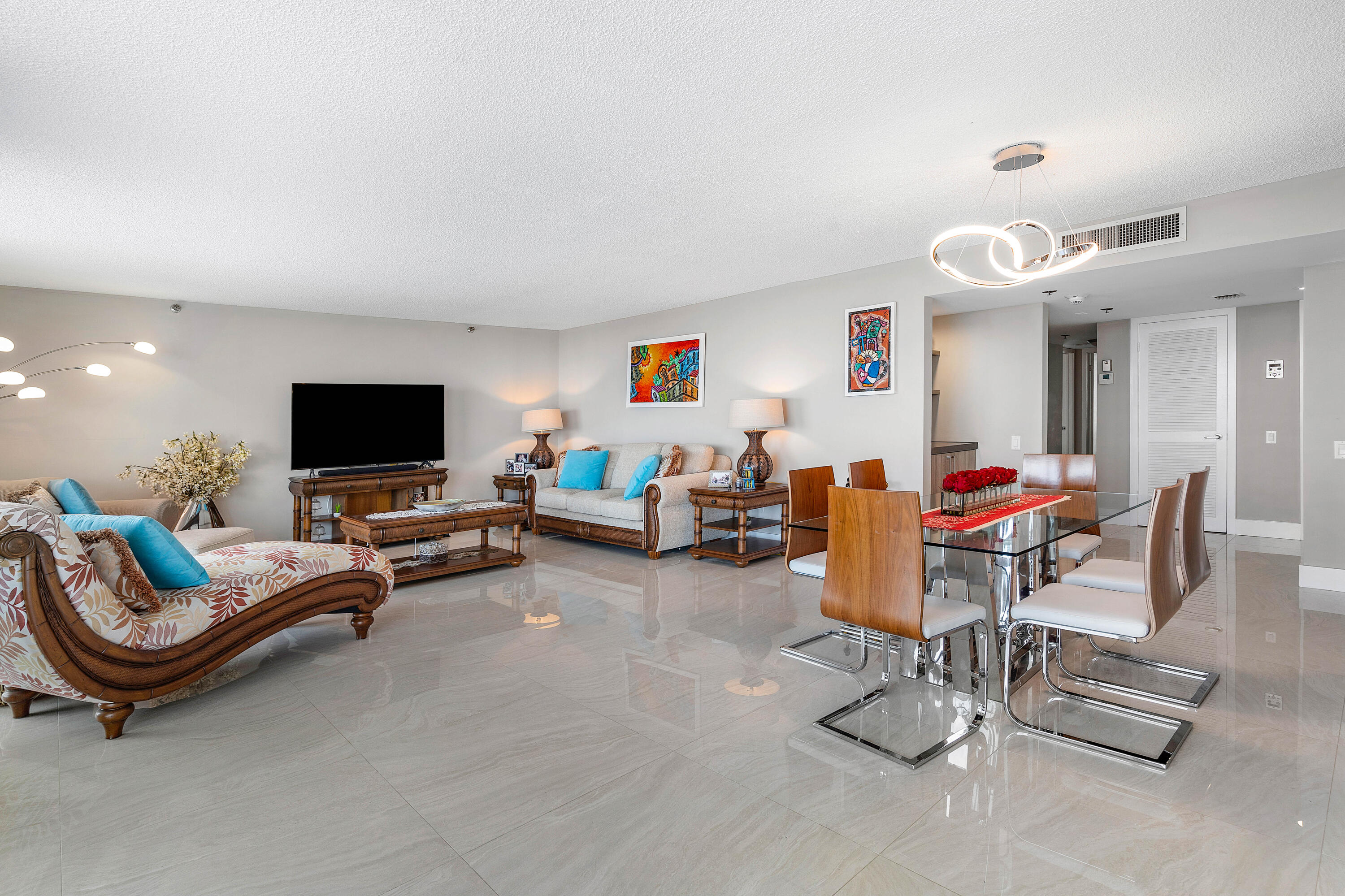 250 South Ocean Boulevard, Unit 7E Boca Raton, FL 33432 - Photo 10 of 45 a living room with furniture and a flat screen tv