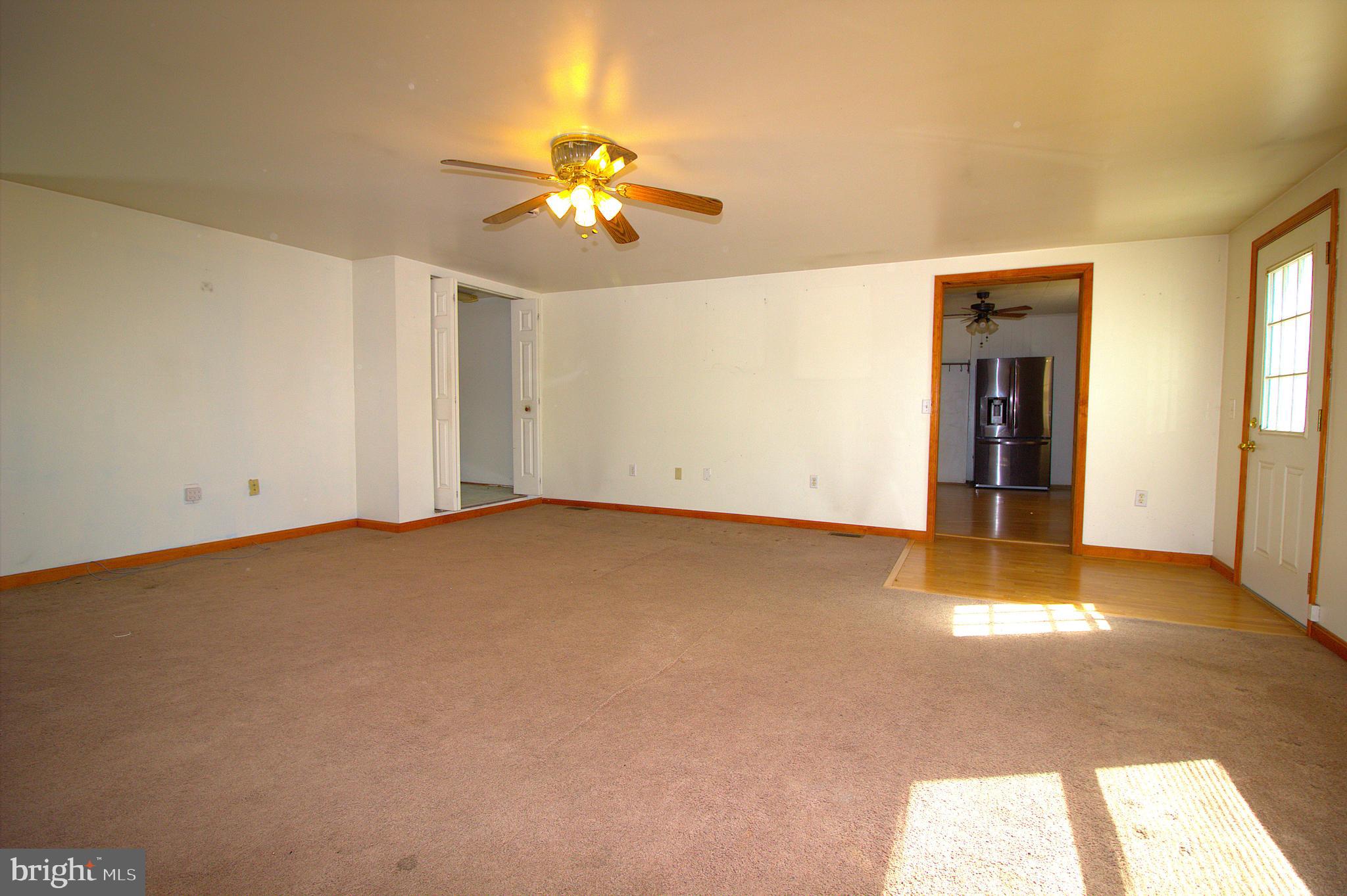 7613 Maple Road Baltimore, MD 21222 - Photo 15 of 32 a view of an empty room with a chandelier fan