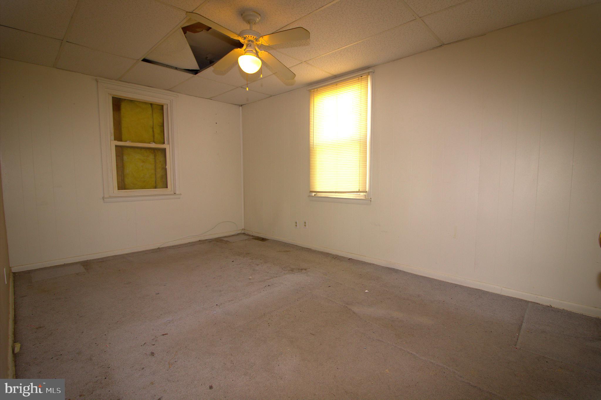 7613 Maple Road Baltimore, MD 21222 - Photo 20 of 32 an empty room with windows and fan
