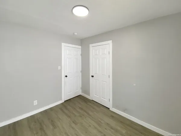 a view of an empty room and wooden floor