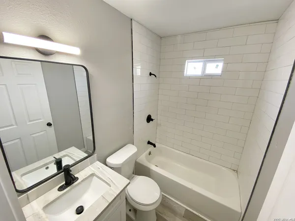 a bathroom with a sink a toilet and a bathtub