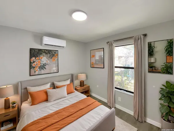 a bedroom with a bed and a painting on the wall