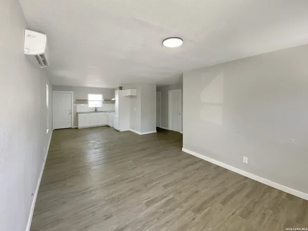 a view of a livingroom with wooden floor and a window