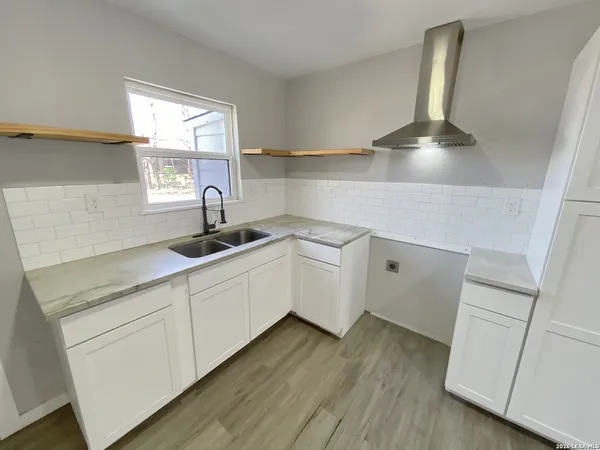 a kitchen with a sink cabinets and window