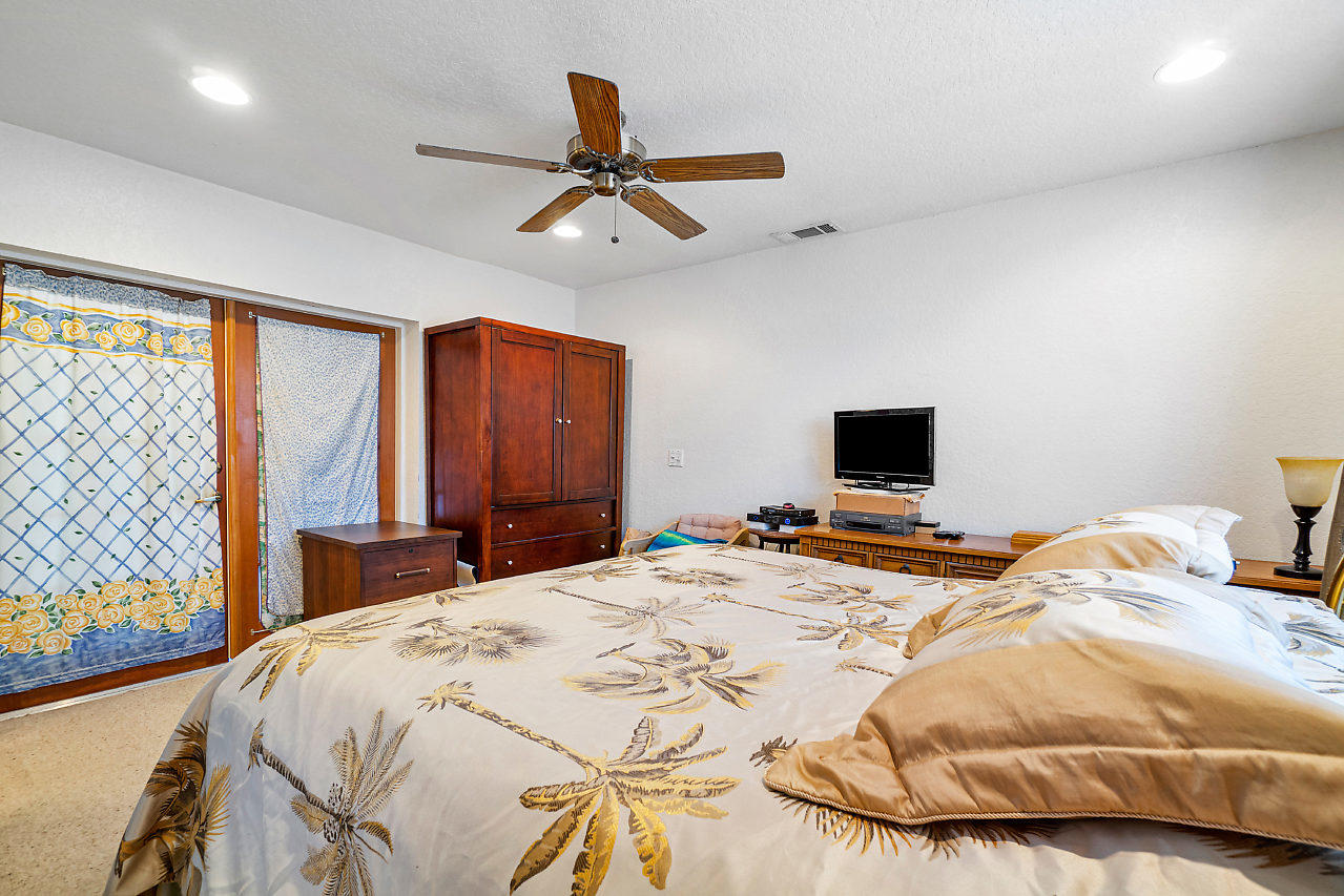 10921 Gable Street Boca Raton, FL 33428 - Photo 11 of 28 a bedroom with a bed and a flat screen tv