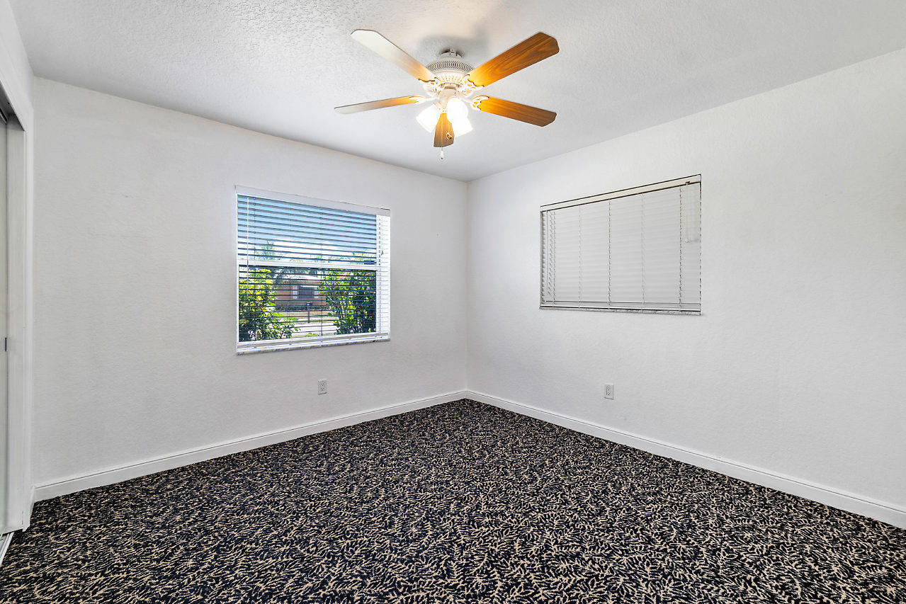 10921 Gable Street Boca Raton, FL 33428 - Photo 13 of 28 wooden floor in an empty room with a window