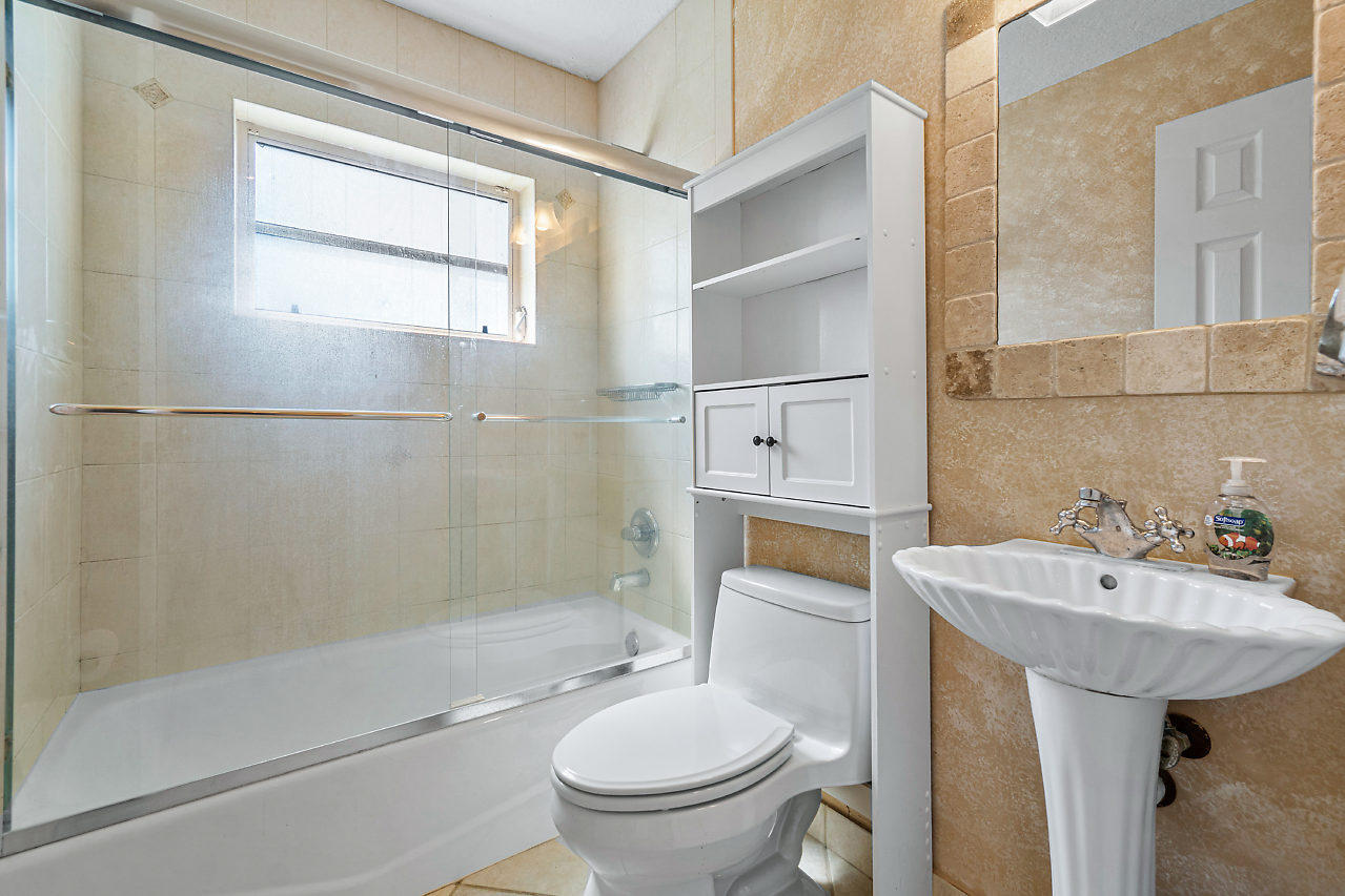 10921 Gable Street Boca Raton, FL 33428 - Photo 14 of 28 a bathroom with a sink toilet and shower