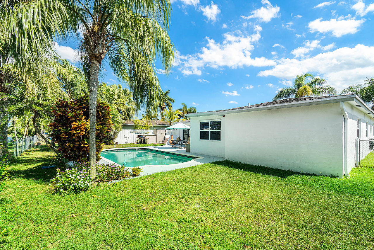 10921 Gable Street Boca Raton, FL 33428 - Photo 18 of 28 a view of a backyard with plants and a garden