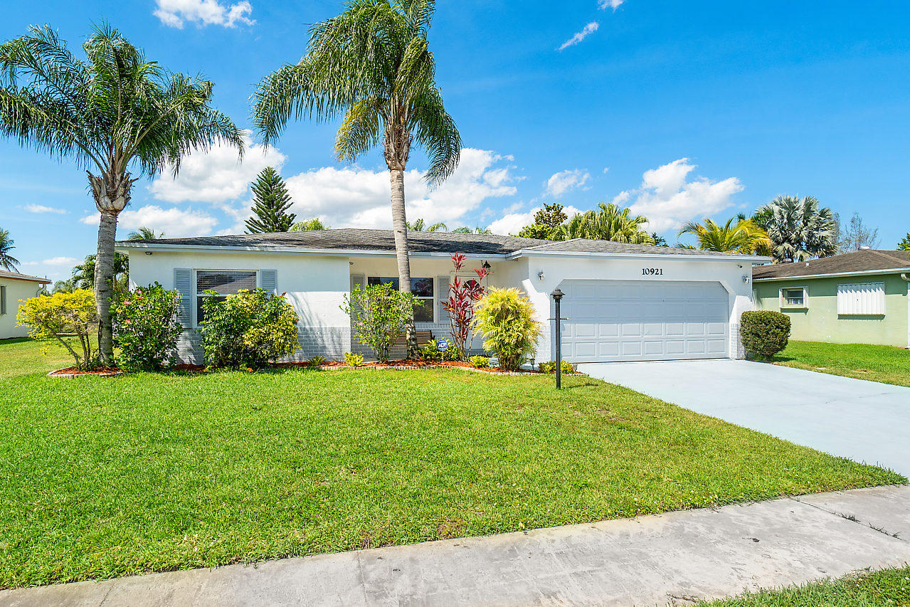10921 Gable Street Boca Raton, FL 33428 - Photo 26 of 28 a front view of house with yard and green space