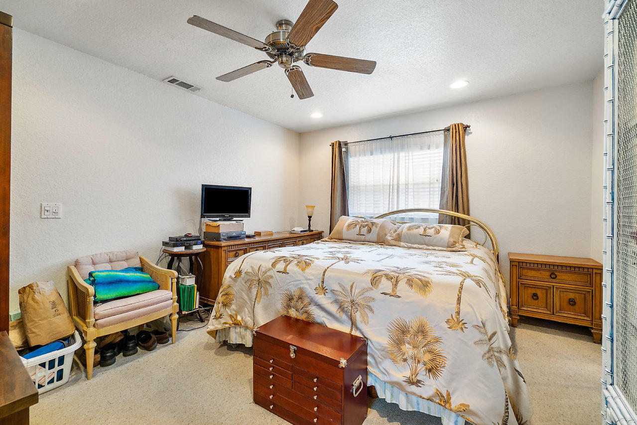 10921 Gable Street Boca Raton, FL 33428 - Photo 10 of 28 a bedroom with a bed and a tv