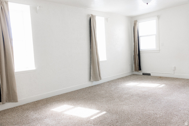 69 South Main Street Manti, UT 84642 - Photo 33 of 44 Spacious room featuring light-colored carpeting and white textured walls