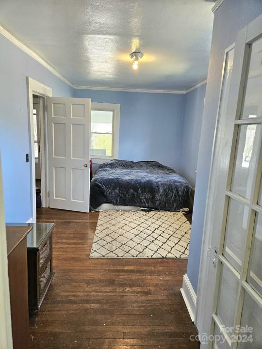 186 Rector Corner Road Marshall, NC 28753 - Photo 12 of 15 a bedroom with a bed and wooden floor