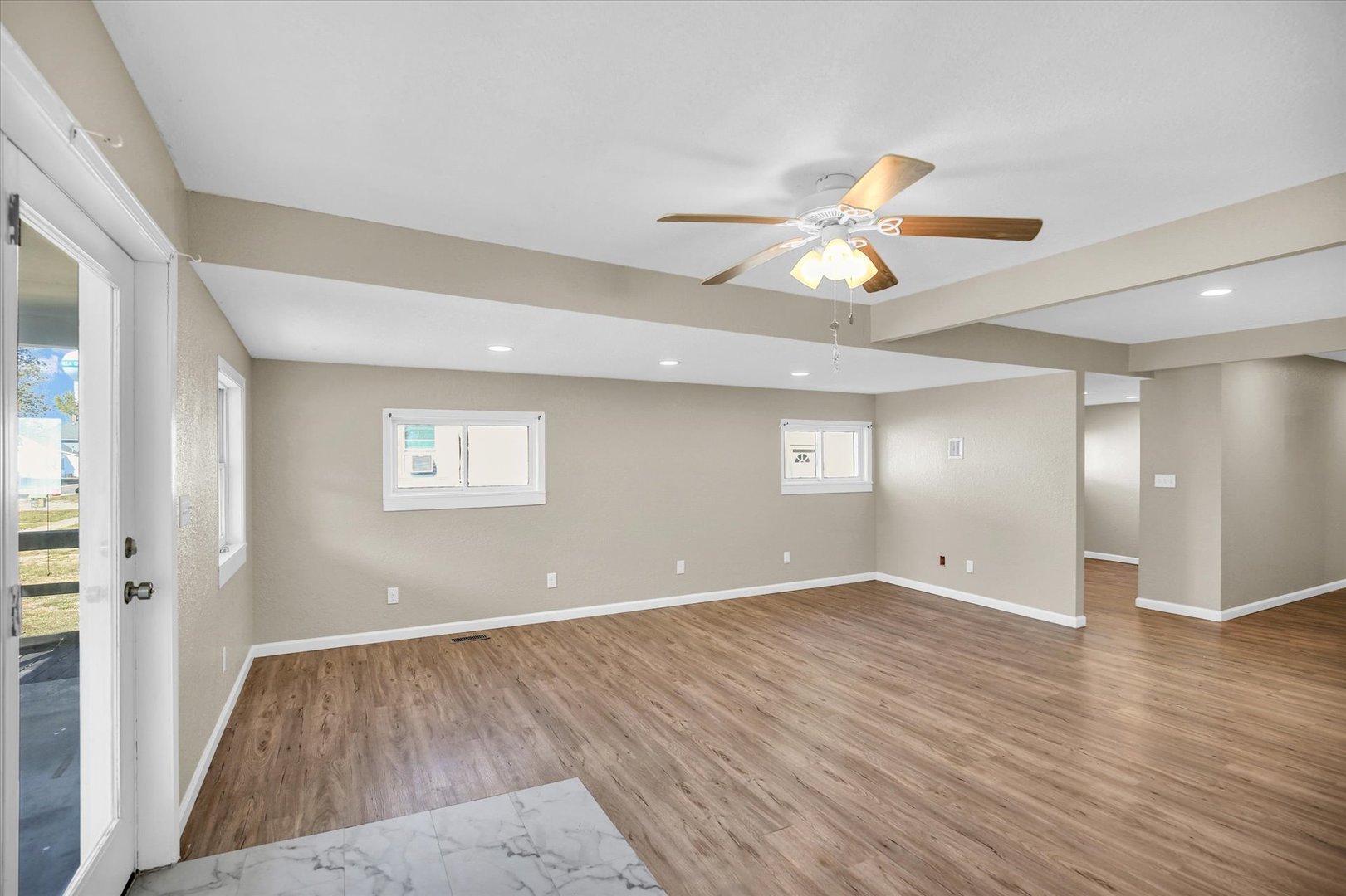 703 South Spruce Street Villa Grove, IL 61956 - Photo 16 of 28 wooden floor in an empty room with a window
