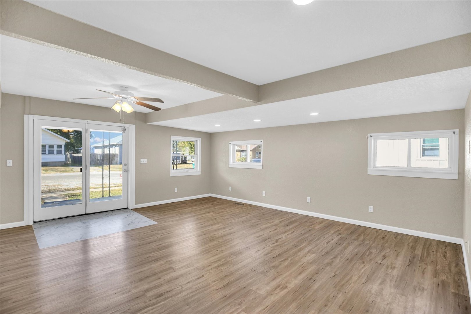 703 South Spruce Street Villa Grove, IL 61956 - Photo 18 of 28 a view of an empty room with wooden floor and a window