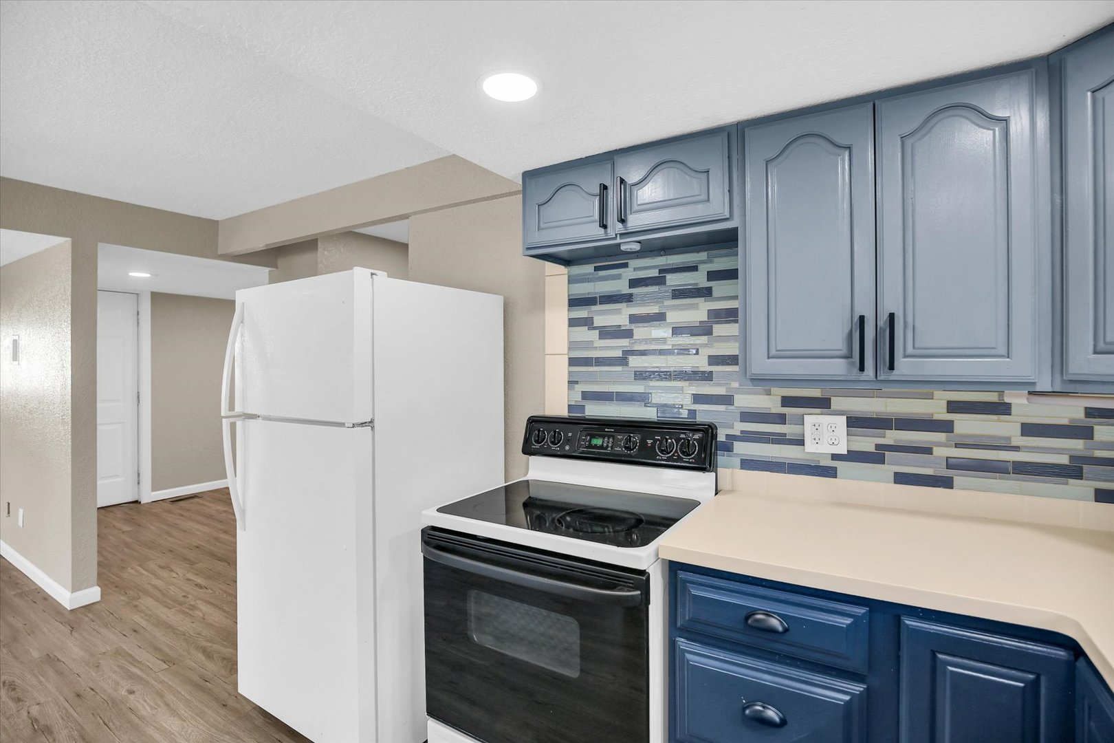 703 South Spruce Street Villa Grove, IL 61956 - Photo 20 of 28 a kitchen with a sink a stove and refrigerator