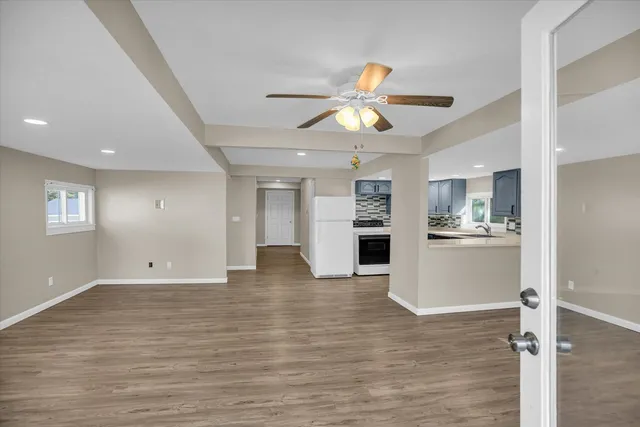 a view of a kitchen with a sink and refrigerator