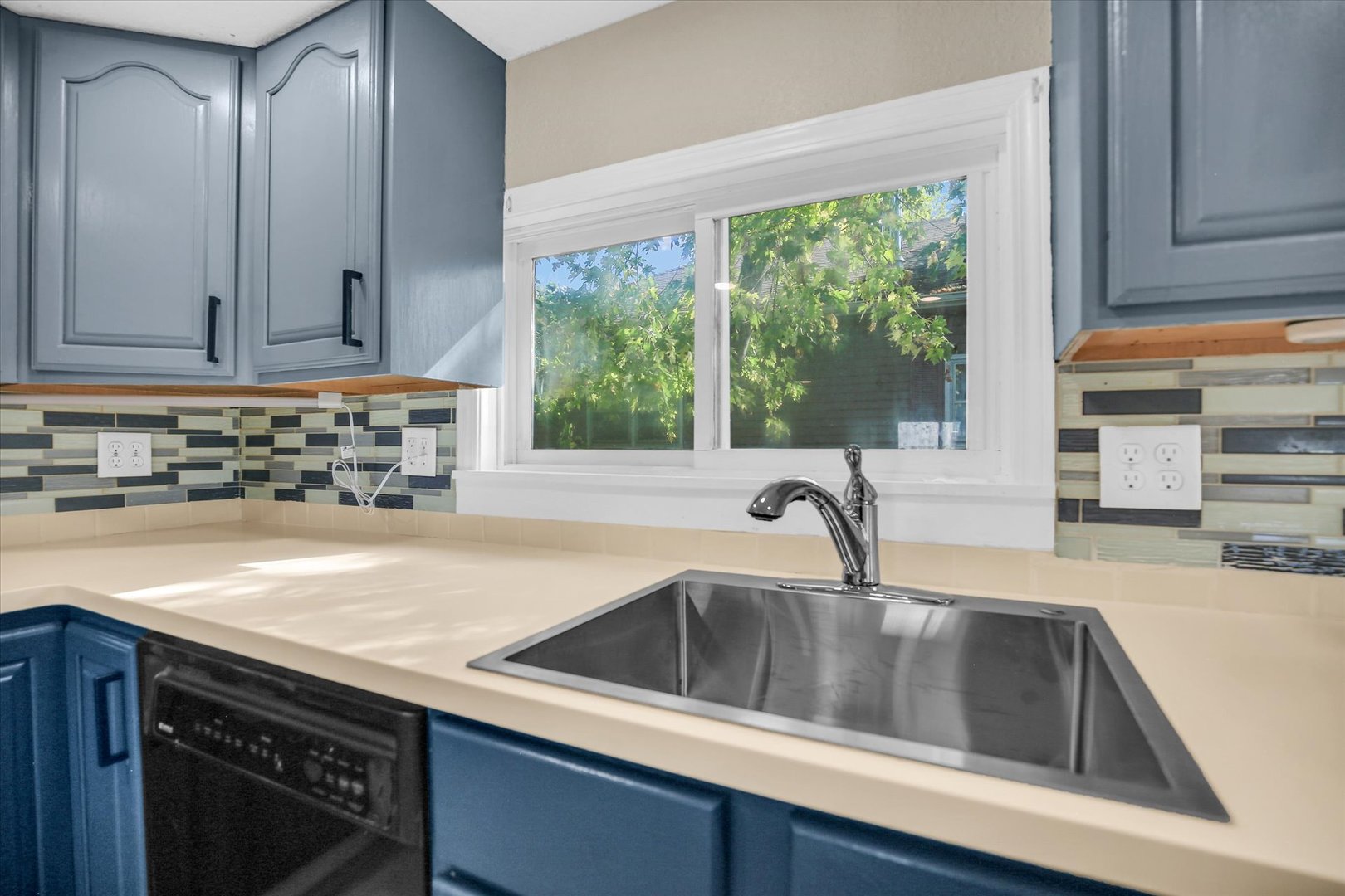 703 South Spruce Street Villa Grove, IL 61956 - Photo 22 of 28 a kitchen with granite countertop a sink and a stove