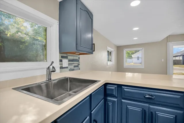 a kitchen with a sink cabinets and window