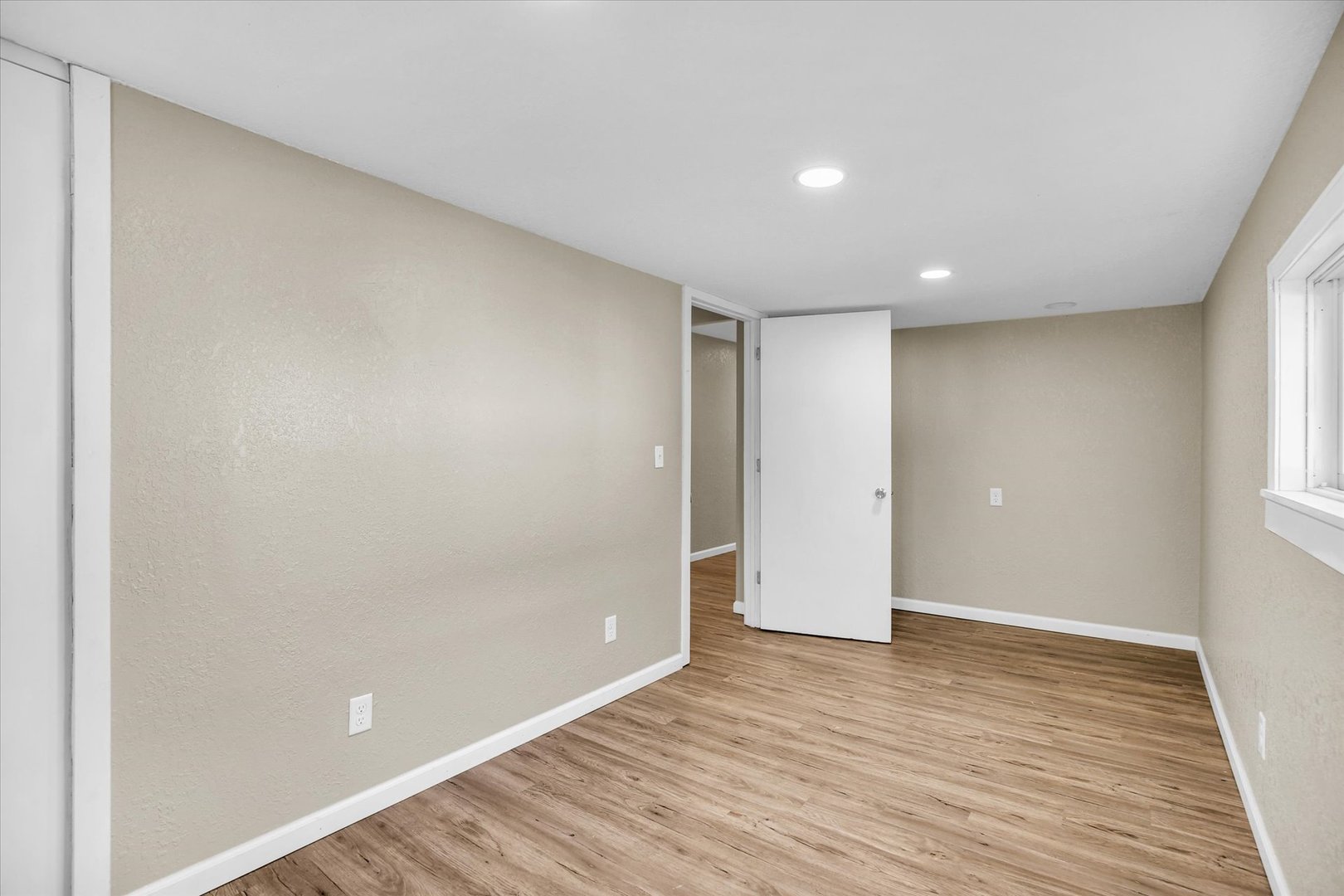 703 South Spruce Street Villa Grove, IL 61956 - Photo 26 of 28 a view of an empty room with wooden floor and a window