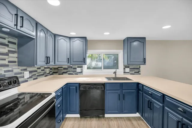 a kitchen with a sink stove and cabinets