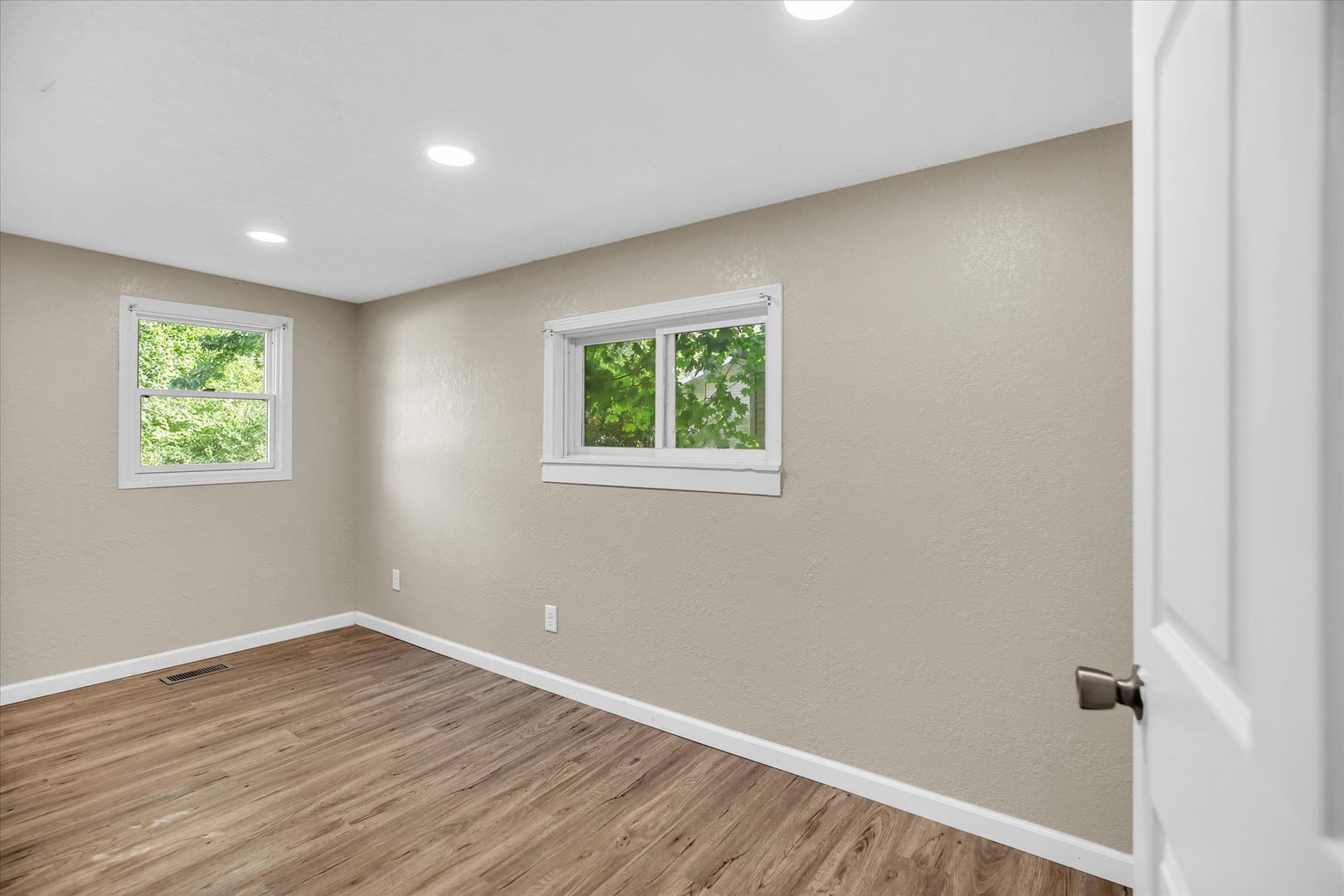 703 South Spruce Street Villa Grove, IL 61956 - Photo 5 of 28 wooden floor in an empty room with a window