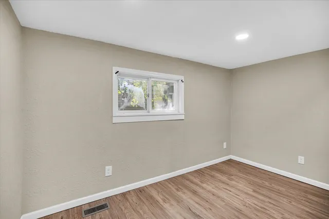 a view of room with wooden floor and window