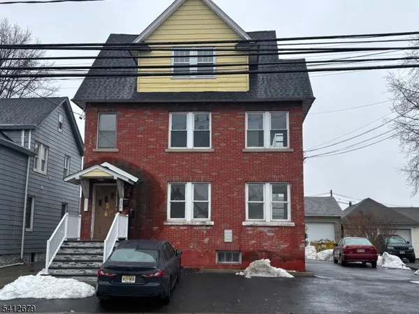 a front view of a house with parking space