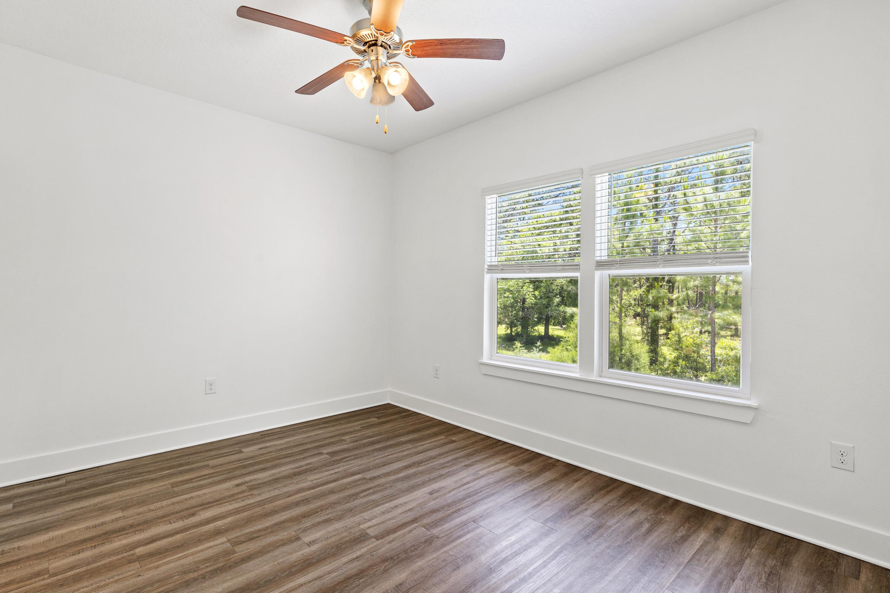 392 North Sand Palm Road Freeport, FL 32439 - Photo 12 of 36 a view of a room with wooden floor and windows