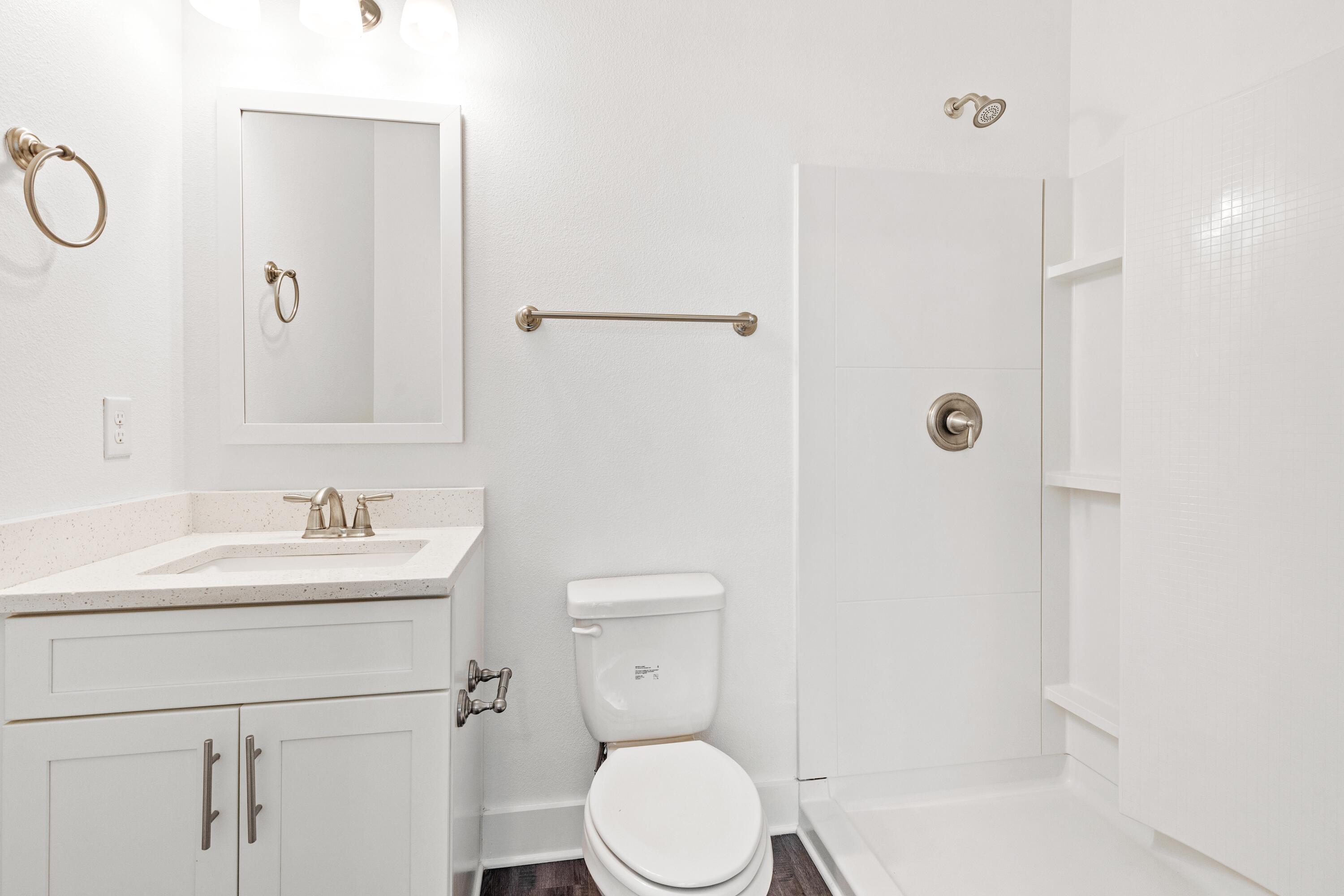 392 North Sand Palm Road Freeport, FL 32439 - Photo 13 of 36 a bathroom with a toilet sink shower and mirror