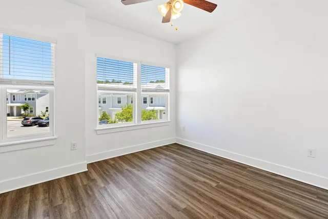 wooden floor in an empty room with a window