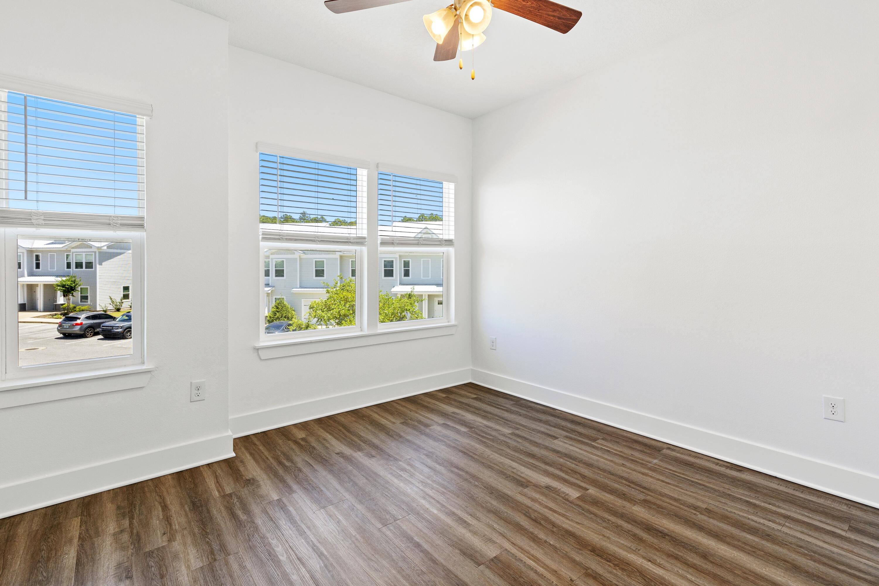 392 North Sand Palm Road Freeport, FL 32439 - Photo 14 of 36 wooden floor in an empty room with a window