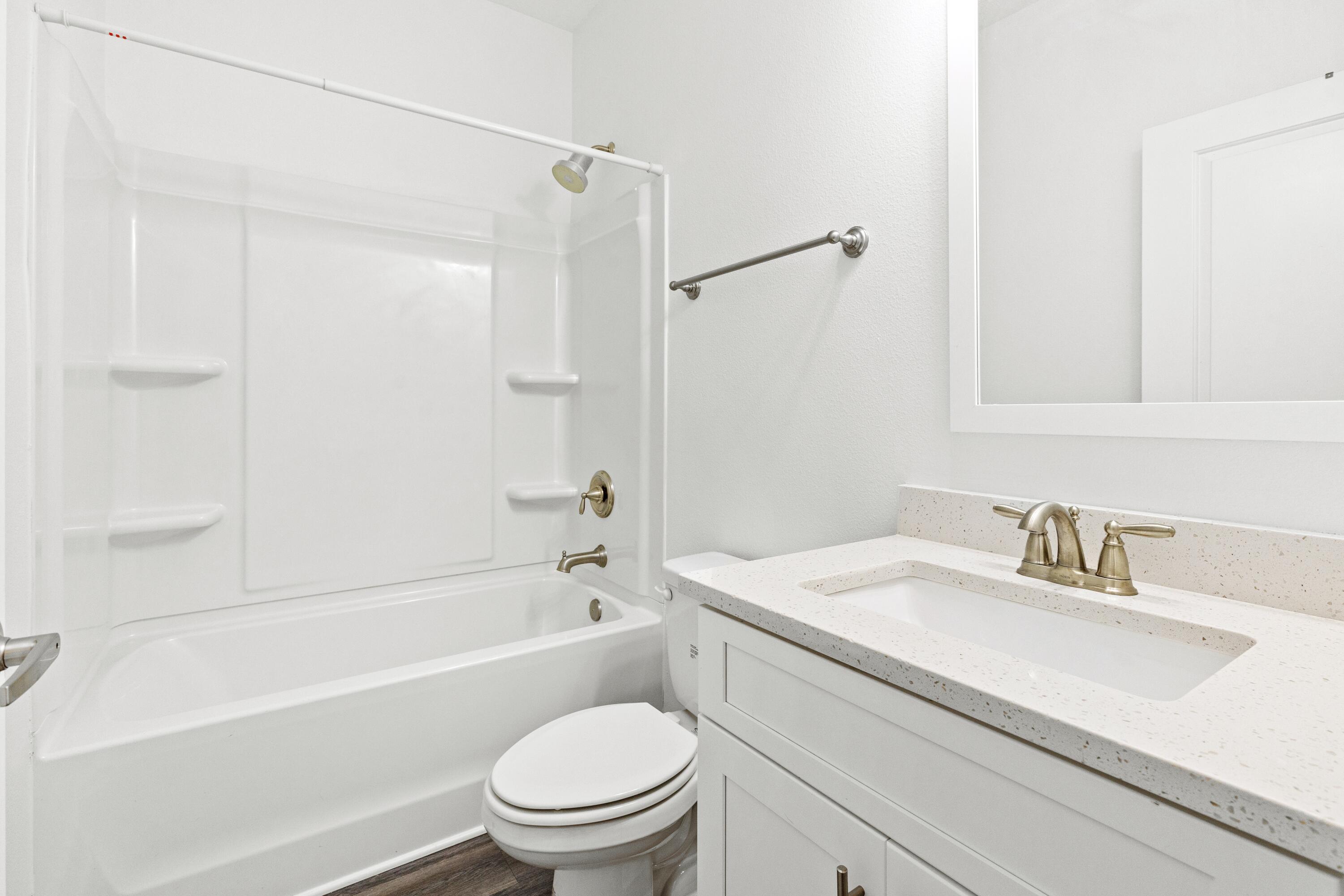 392 North Sand Palm Road Freeport, FL 32439 - Photo 16 of 36 a bathroom with a sink a toilet and a bathtub