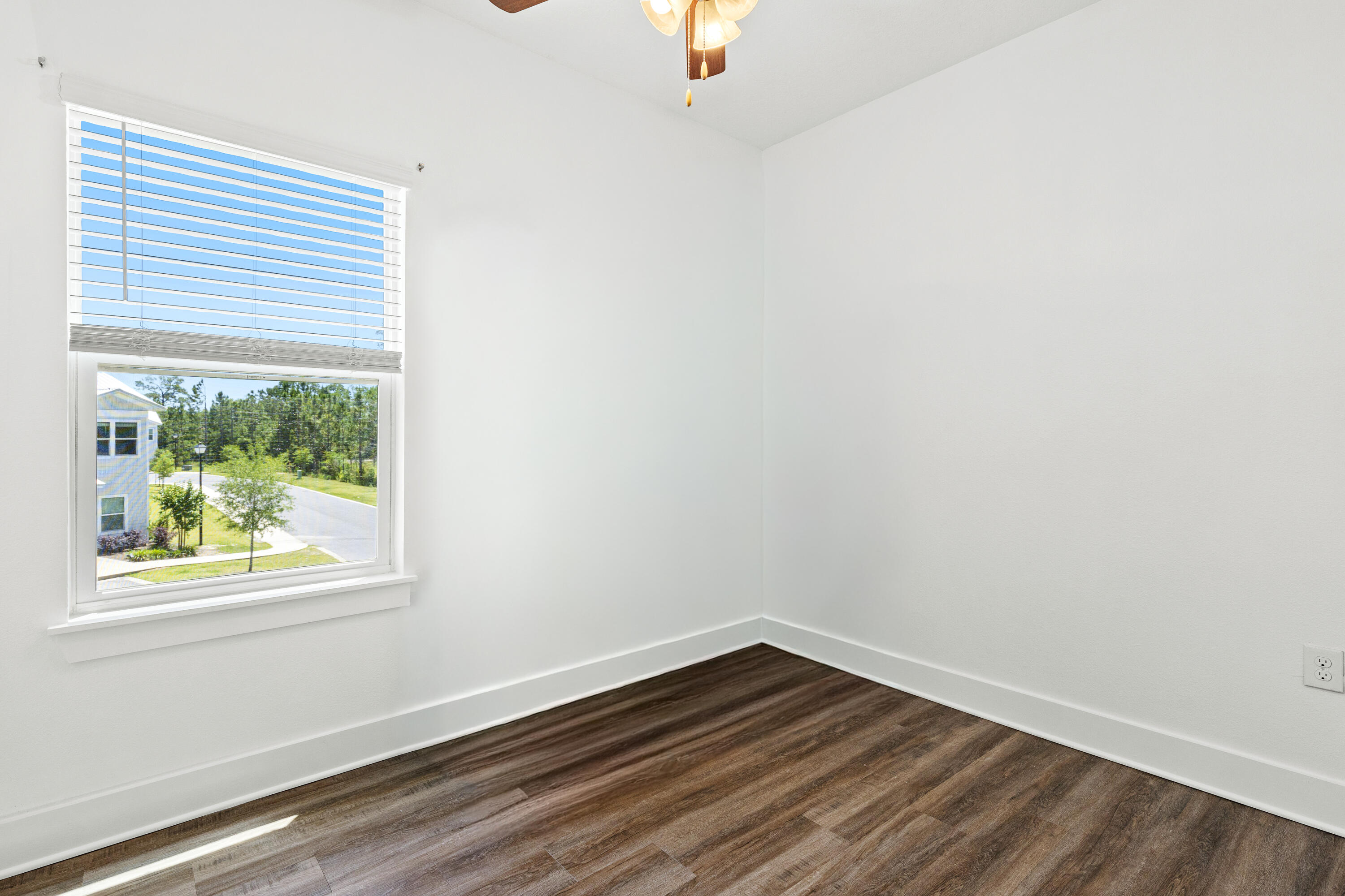 392 North Sand Palm Road Freeport, FL 32439 - Photo 17 of 36 an empty room with wooden floor and windows