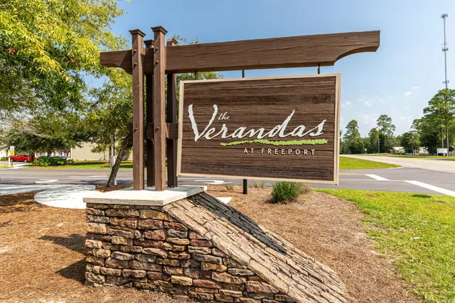 a sign board on the side of a street