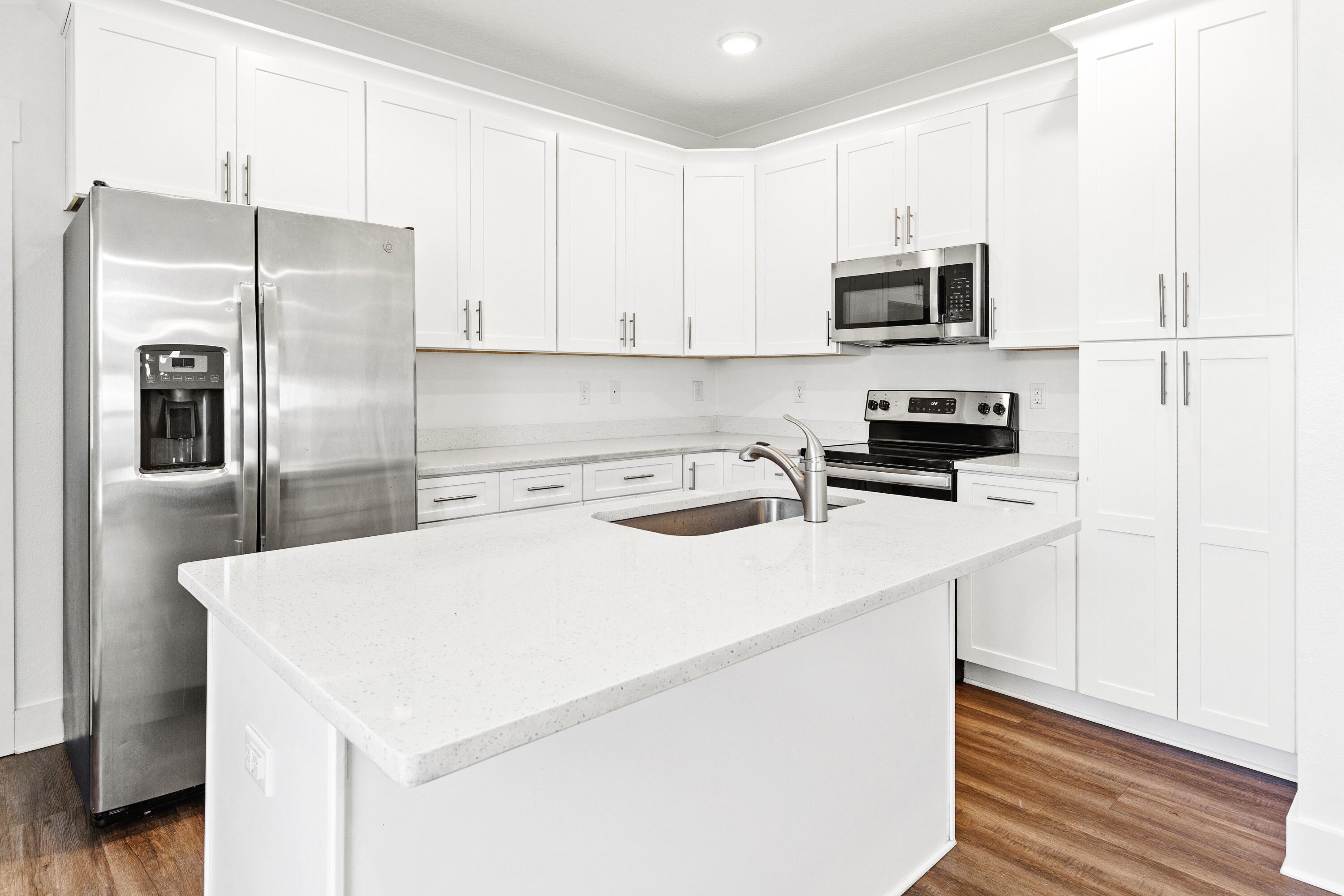 392 North Sand Palm Road Freeport, FL 32439 - Photo 4 of 36 a kitchen with stainless steel appliances a refrigerator sink and microwave