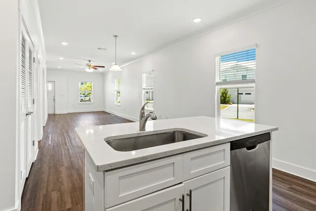 a kitchen with kitchen island a sink stainless steel appliances and cabinets