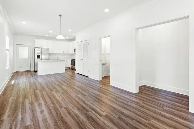 a view of kitchen view wooden floors appliances and cabinets
