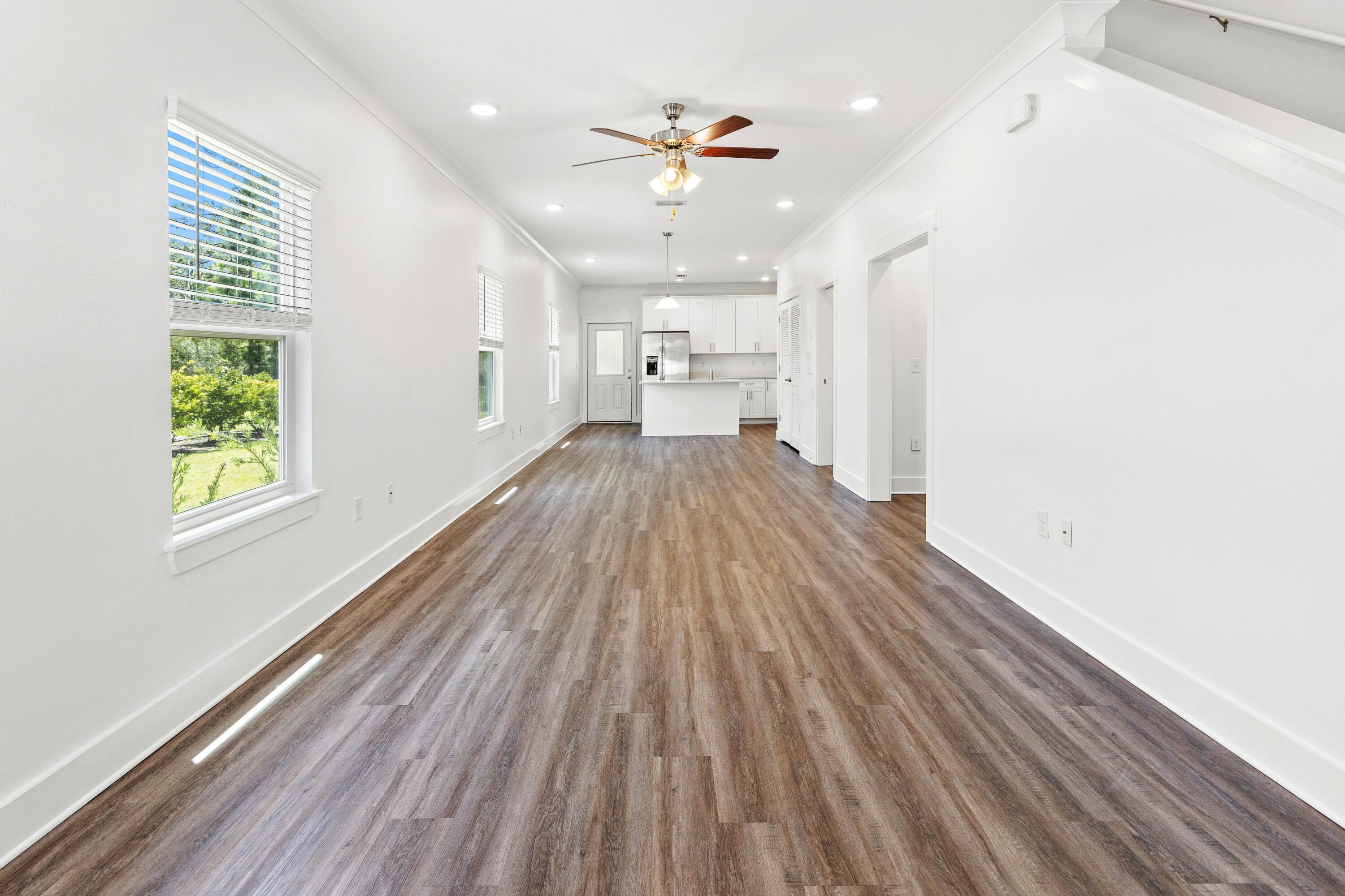 392 North Sand Palm Road Freeport, FL 32439 - Photo 8 of 36 wooden floor in an empty room with a window