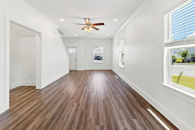 wooden floor in an empty room with a window