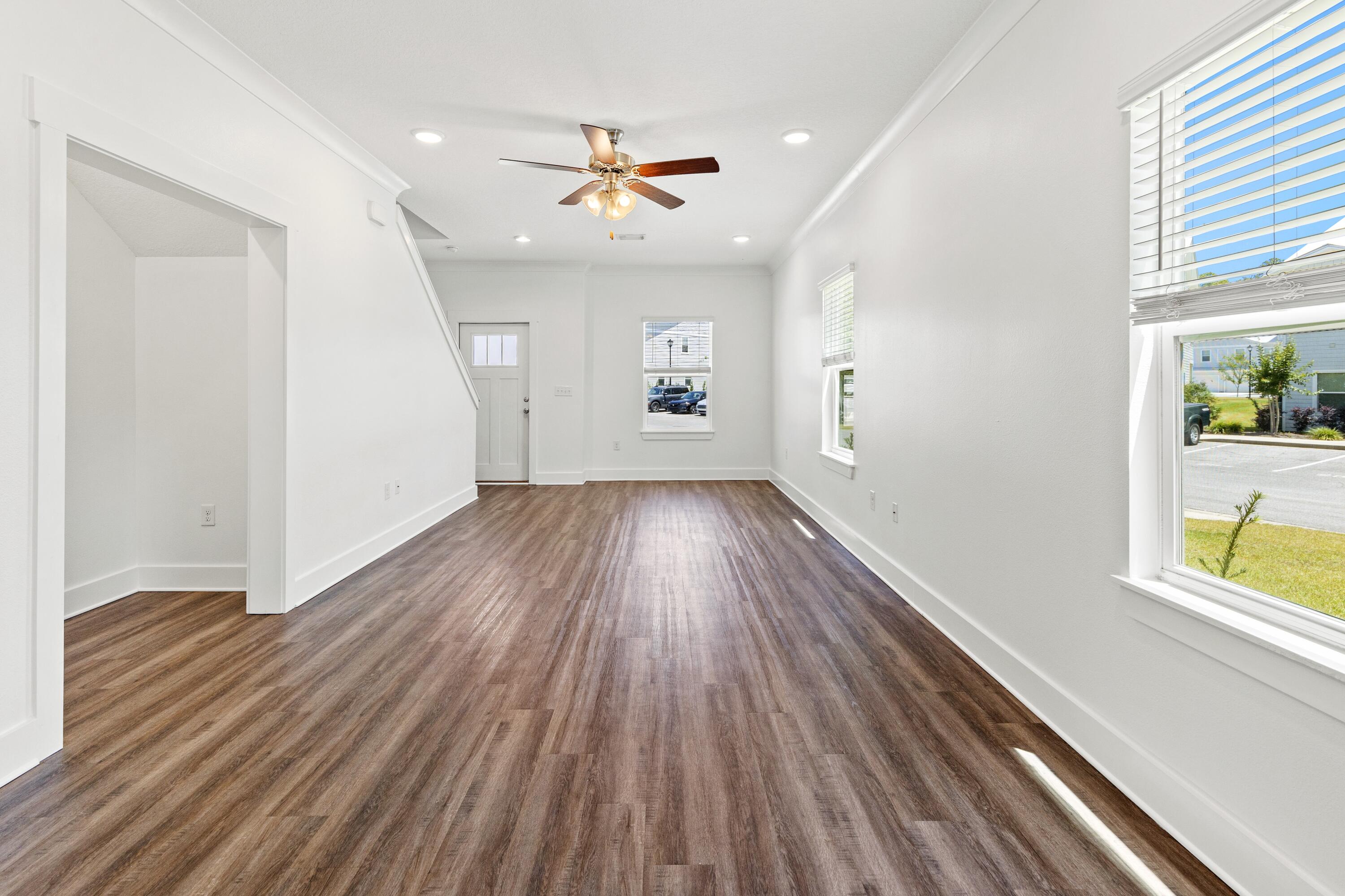 392 North Sand Palm Road Freeport, FL 32439 - Photo 9 of 36 wooden floor in an empty room with a window