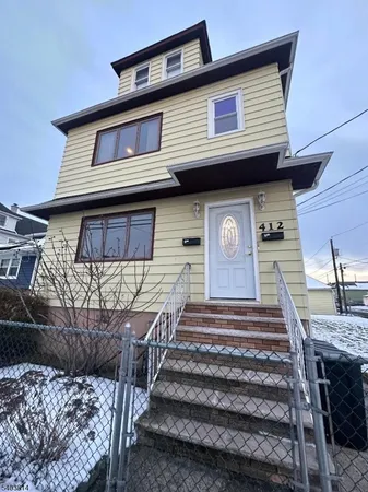 a front view of a house with stairs