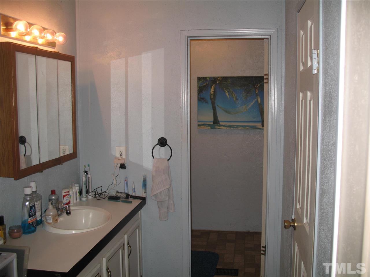 145 Ridgewood Drive Middlesex, NC 27557 - Photo 15 of 20 a bathroom with a sink and a mirror