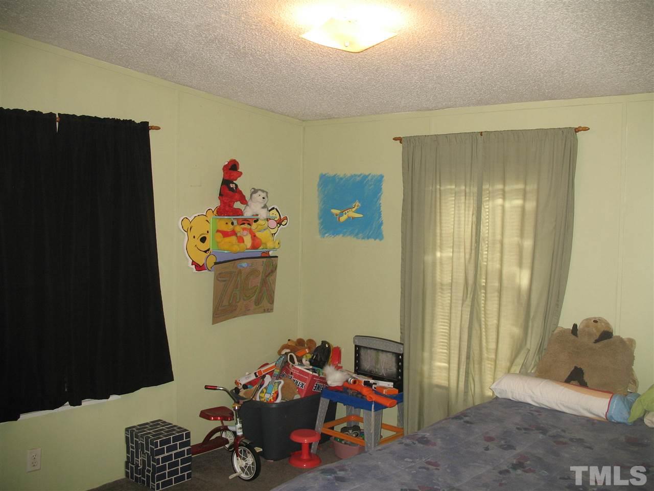 145 Ridgewood Drive Middlesex, NC 27557 - Photo 18 of 20 a children room with toys and a couch