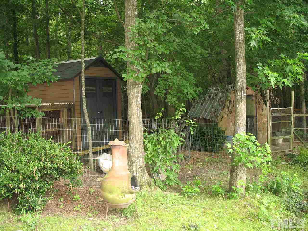 145 Ridgewood Drive Middlesex, NC 27557 - Photo 5 of 20 a view of a backyard with plants and large trees