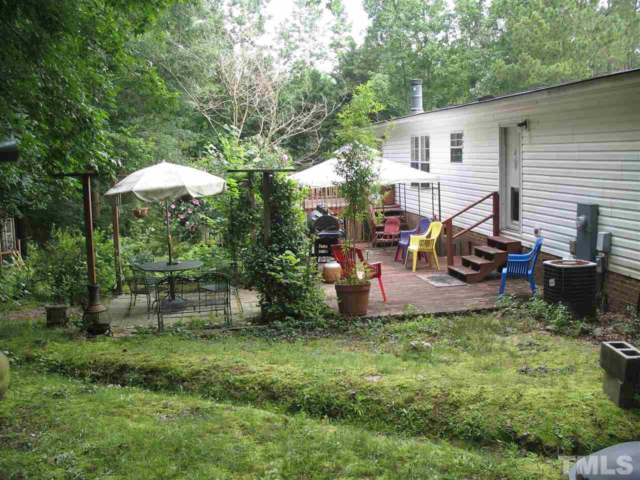 145 Ridgewood Drive Middlesex, NC 27557 - Photo 6 of 20 a view of a chairs and table in backyard of the house
