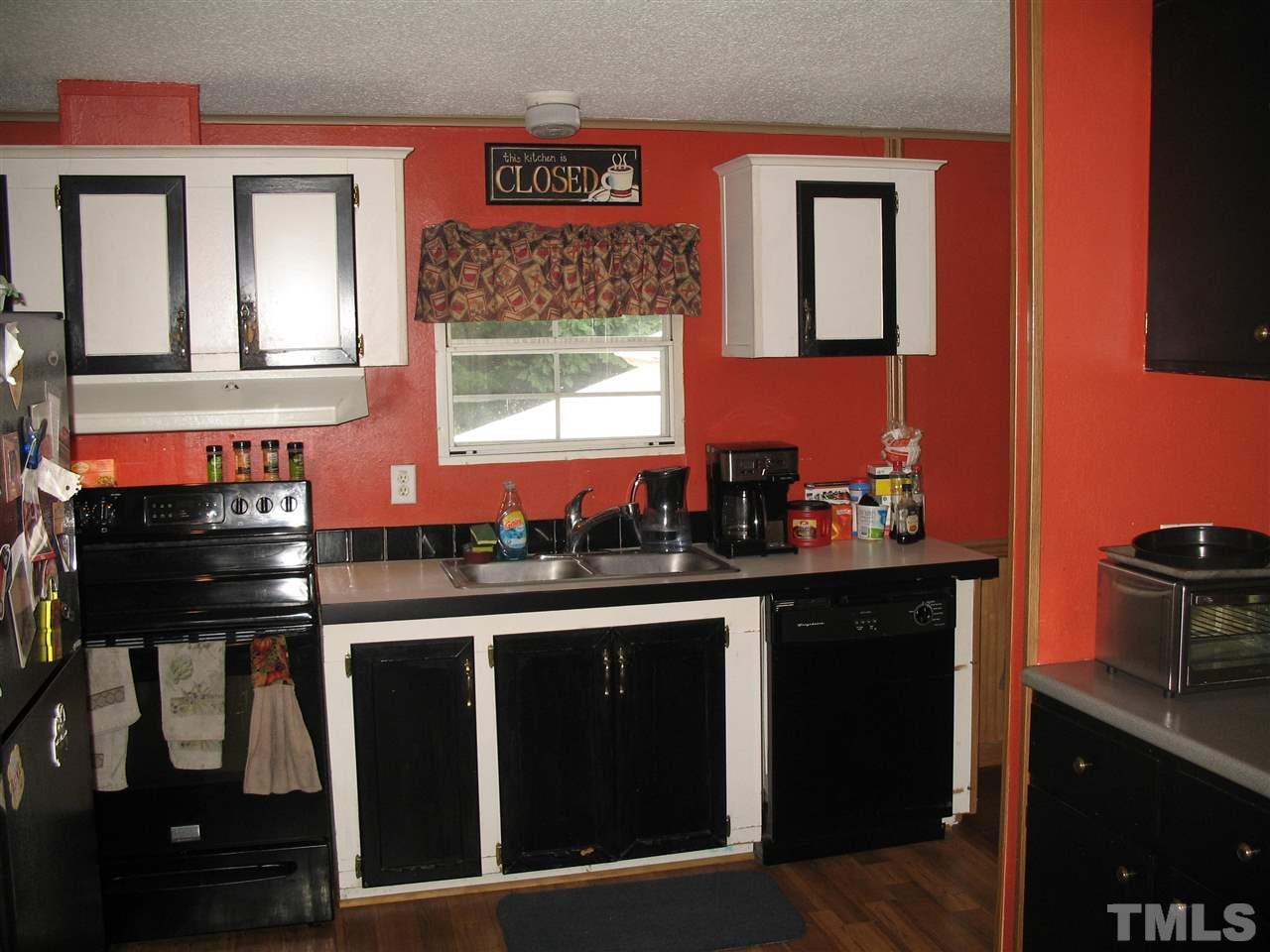 145 Ridgewood Drive Middlesex, NC 27557 - Photo 9 of 20 a kitchen with stainless steel appliances a sink stove and cabinets