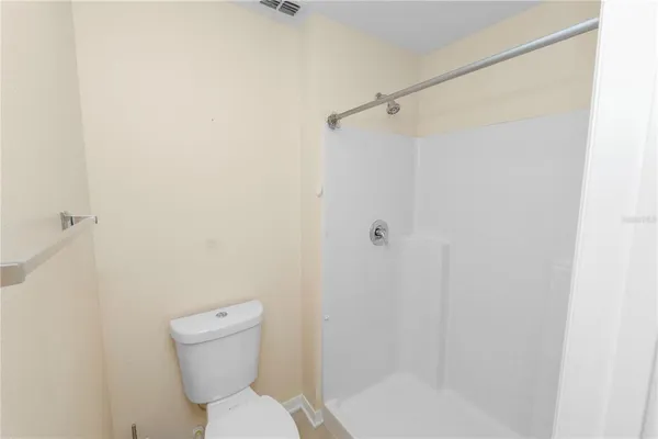 a bathroom with a toilet and a shower