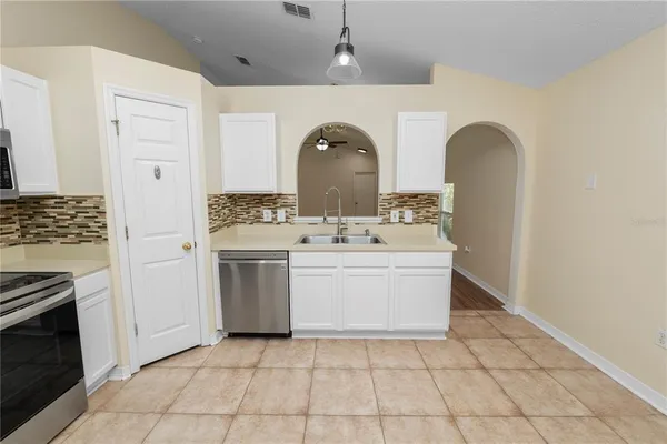 a kitchen with a stove and a sink