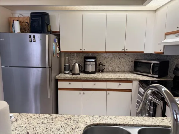 a kitchen with a refrigerator and a sink